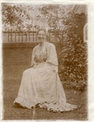 Photograph, early print of Pollie Baker in garden.