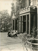 Photograph of two women, one of them Margaret Baker, in garden