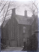 Glass negative of part exterior of part of a house