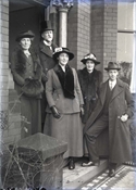 Glass negative of five members of Baker family on steps of Epworth House.