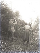 Glass negative of two members of Baker family gardening at Beaconfield.
