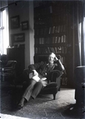 Glass negative of Harry Baker seated in armchair