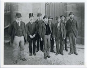 Photograph, modern print, group of men in stone church-like building
