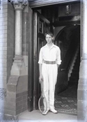 Glass negative of one of Baker sons standing in doorway of Epworth House.