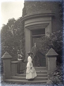 Glass negative showing people on steps of Beaconfield House.