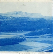 Glass plate, tinted blue, of hills and woods