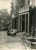 Photograph of two women, one of them Margaret Baker, in the garden