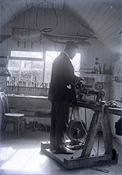 Glass negative of Harry Baker in workshop