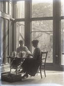 Glass negative of two Baker women, bottling fruit at Beaconfield.