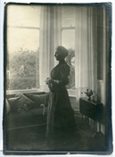Print from glass negative of Pollie Baker in front of window at Epworth House.